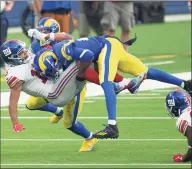  ?? Kyusung Gong / Associated Press ?? Los Angeles Rams cornerback Jalen Ramsey (20), right, tackles New York Giants wide receiver Golden Tate (15) on Sunday in Inglewood, Calif. After the game, Tate was involved in a scuffle with Ramsey.