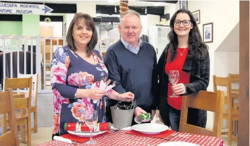  ??  ?? Alison Hughes, Aled Morris-Jones and Nicola Collins preparing for the Christmas dinner at the Sail Loft