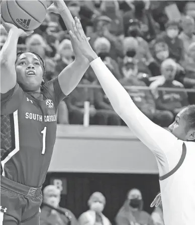  ?? ?? South Carolina’s Zia Cooke shoots over North Carolina State’s Camille Hobby on Tuesday in Raleigh, N.C.