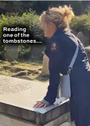  ??  ?? Reading one of the tombstones…