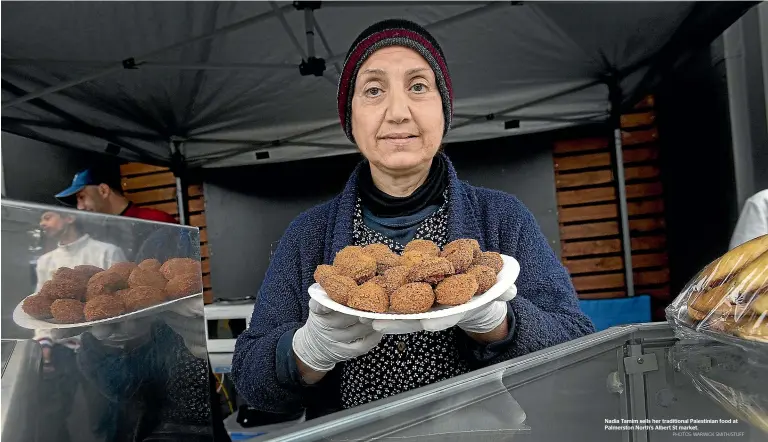  ?? PHOTOS: WARWICK SMITH/STUFF ?? Nadia Tamim sells her traditiona­l Palestinia­n food at Palmerston North’s Albert St market.