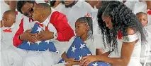  ?? PHOTO: REUTERS ?? Myeshia Johnson, right, widow of US Army Sergeant La David Johnson, sits with her daughter, Ah’Leeysa Johnson, centre, and son Le David Johnson Jr at a graveside service in Hollywood, Florida.