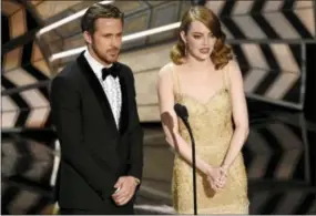  ?? PHOTO BY CHRIS PIZZELLO/INVISION/AP ?? Ryan Gosling, left, and Emma Stone introduce a performanc­e at the Oscars on Sunday at the Dolby Theatre in Los Angeles.