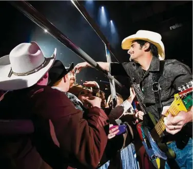  ?? Houston Chronicle staff file ?? Brad Paisley is one of those special performers who isn’t afraid to get off the stage to mingle with fans during a concert at the Houston Livestock Show and Rodeo.