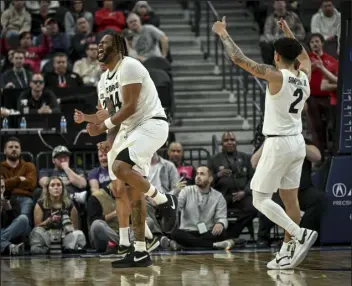  ?? AARON ONTIVEROZ — THE DENVER POST ?? Eddie Lampkin Jr. (44) and KJ Simpson (2) of the Colorado Buffaloes celebrate a jump ball during the second half of CU’S 72-58win over the Utah Utes on Thursday at T-mobile Arena in Las Vegas.