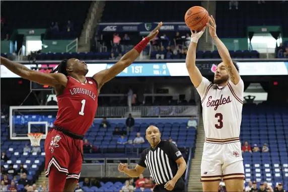  ?? CHUCK BURTON — THE ASSOCIATED PRESS ?? Boston College guard Jaeden Zackery shoots against Louisville guard Mike James during the first half. BC rolled to an 80-62 win in Greensboro, N.C., on Tuesday.