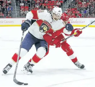  ?? PAUL SANCYA/THE CANADIAN PRESS ?? Florida Panthers centre Aleksander Barkov (16) protects the puck from Detroit Red Wings defenceman Jonathan Ericsson in a game on Jan. 5.