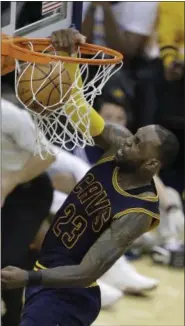  ?? DARRON CUMMINGS — THE ASSOCIATED PRESS FILE ?? In this April 20photo, Cleveland Cavaliers’ LeBron James dunks during the second half in Game 3of the team’s firstround NBA basketball playoff series against the Indiana Pacers, in Indianapol­is.