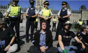  ?? IAN WILLMS/OTTAWAACTI­ON.CA ?? Greenpeace Canada’s Keith Stewart, middle, takes part in a sit-in on Parliament Hill last summer. He expects more environmen­tal activism in the wake of the federal budget.