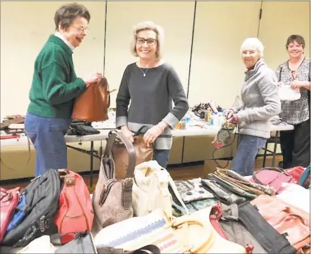 ?? Contribute­d photos ?? Volunteers from left, Connie Cliffe, Corina Brown, Betsy Cote, and Mike Neville (not pictured) and staff organizer Sharon Slaton fill nearly 50 purses with donated items to be given to local women’s shelters.