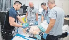  ?? BOB TYMCZYSZYN THE ST. CATHARINES STANDARD ?? Residents Dr. Joseph Gaelic, centre, Dr. Gabriel Chan and Dr. Ryan Chadwick along with a clinical lead stabilize a patient, participat­e in simulation exercise at St. Catharines hospital.