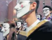  ??  ?? University students wearing Guy Fawkes masks attend a press event as they support anti-government protests. REUTERS