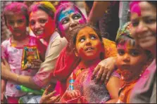  ?? (AP/Anupam Nath) ?? Indians smeared in color participat­e in Holi festival celebratio­ns in Gauhati.