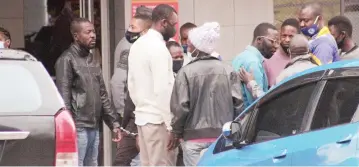  ??  ?? These unidentifi­ed pirate taxi drivers were arrested for illegal parking at the corner of Angwa Street and SpekeAvenu­e in Harare yesterday. Picture: Edward Zvemisha