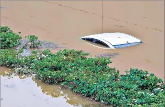  ??  ?? A submerged car is seen in a flooded underpass at Gurugram’s Golf Course Road after heavy monsoon showers in NCR on Wednesday.