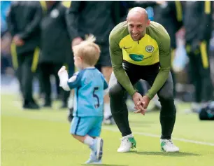  ?? — Reuters ?? Manchester City’s Pablo Zabaleta plays with his son Asier during a training session.