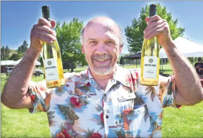  ?? STEVE MacNAULL/The Okanagan Weekend ?? Don Bartier of Bartier Brothers in Oliver shows off bottles of the winery’s Obrigado, which is the Portuguese word for thank you.