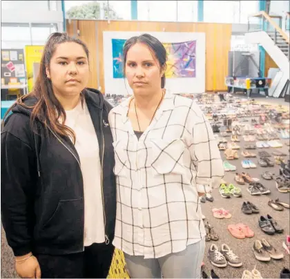  ??  ?? Jamie Lynn, left, and sister Kylie Shanks pictured in March with 606 shoes representi­ng a life lost to suicide last year.
