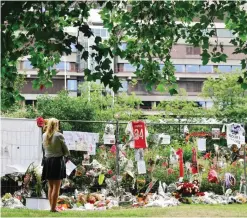  ?? — AFP ?? AMSTERDAM: A visitor stands in silence next to items placed by the hospital where the Ajax midfielder Abdelhak Nouri receives treatments in Amsterdam on Sunday.