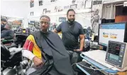  ?? [AP?PHOTO] ?? Barber Eric Muhammad, owner of A New You Barbershop, measures the blood pressure of customer Marc M. Sims on Sunday in Inglewood, Calif.