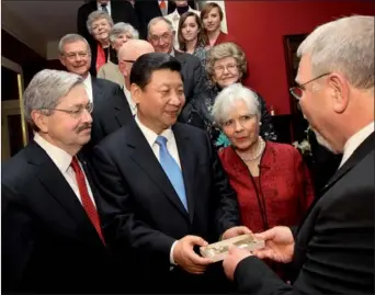  ?? LAN HONGGUANG / XINHUA ?? Iowa Governor Terry Branstad accompanie­s Xi Jinping, then Chinese vice-president, during Xi’s visit to Iowa on February 15, 2012, when he receives a golden key to Muscatine, Iowa from Mayor DeWayne Hopkins (right).