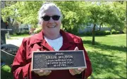  ??  ?? Judy Grant, former principal of Lathrop Elementary School, shows the plaque for Lillie Wilson.