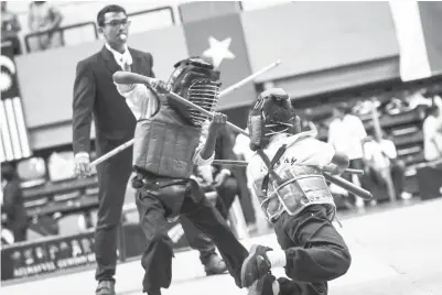  ??  ?? AKSI dua peserta cilik Silambam bertarung pada ‘First Gewinn Malaysia Open Internatio­nal Silambam Championsh­ip 2017’ di Stadium Badminton Kuala Lumpur, Jalan Cheras, kelmarin. -Gambar Bernama