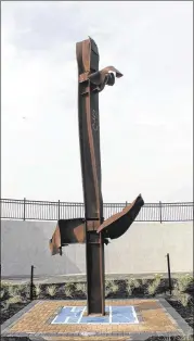  ?? FRANK ELTMAN / AP ?? A piece of steel from the destroyed World Trade Center stands at a new memorial being dedicated today in Point Lookout, N.Y. In addition to listing the 3,000 people killed on Sept. 11, the memorial will include the names of people who died from...