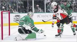  ?? Tony Gutierrez Associated Press ?? STARS GOALTENDER Jake Oettinger tries to stop the Ducks’ Frank Vatrano.