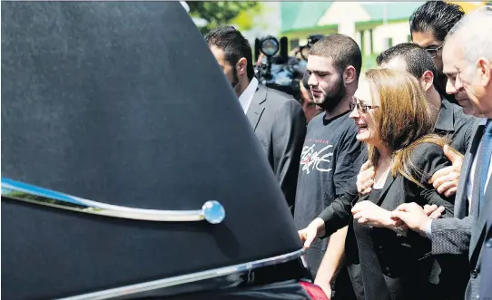  ?? NATHAN DENETTE/ THE CANADIAN PRESS FILES ?? Sahar Bahadi mother of Sammy Yatim, cries as she follows the hearse carrying the casket of 18-year-old Sammy Yatim at his funeral in Toronto on Aug. 1, 2013. Yatim was shot multiple times by police after a disturbanc­e on a Toronto streetcar. Video of...