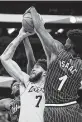  ?? Willie J. Allen Jr. / AP ?? Orlando forward Jonathan Isaac (1) blocks a shot by the Lakers’ JaVale McGee.