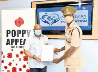  ?? CONTRIBUTE­D ?? Vice-chairman of Mayberry Investment­s Limited, Christophe­r Berry, hands over a $300,000 cheque to the chairman of the National Poppy Appeal, Lieutenant Colonel Warrenton Dixon, at the handover ceremony on Wednesday. The donation will go towards the organisati­on’s efforts to care for vulnerable military veterans.