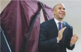  ?? Julio Cortez, The Associated Press ?? Newark Mayor Cory Booker walks out of a polling boothWedne­sday after voting in a special election for New Jersey’s vacant Senate seat.