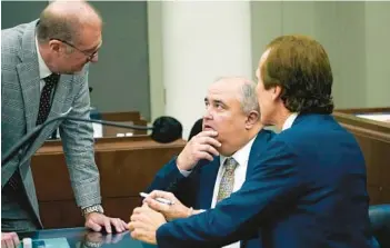  ?? ROGELIO V. SOLIS/AP ?? John Davis, center, former director of the Mississipp­i Department of Human Services, confers with defense attorneys Charles Mullins, left, and Merrida Coxwell on Thursday in Jackson. Davis pleaded guilty to state and federal charges.