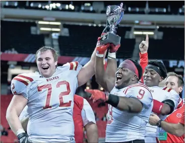  ?? Steven Eckhoff / Rome News-Tribune ?? Rome seniors Zach Kadum (left) and Malik Davis hoist the state championsh­ip trophy Friday night at the Georgia Dome.
TOP: Preston Brinkley (from left), 7, Asher Brinkley, 6, Greta Brinkley, 4, stay up late Friday night with mom Clarissa Brinkley to...