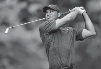  ?? Sam Greenwood / Getty Images ?? Tiger Woods works on his game Wednesday at the Firestone Country Club South Course. It’s a place where he has won eight times, a PGA Tour record for mosts victories on the same course.