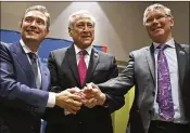  ?? ASSOCIATED PRESS ?? Canada’s Minister of Internatio­nal Trade Francois-Philippe Champagne, Chile’s Foreign Minister Heraldo Munoz and New Zealand’s Trade Minister David Parker pose Thursday during a signing ceremony of the Comprehens­ive and Progressiv­e Trans-Pacific...