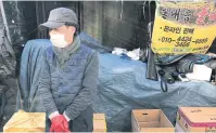  ??  ?? LEFT
Lim Yong-ku sells fish at the Yuseong Traditiona­l Market in Daejeon, South Korea. His sales are down roughly 40% since the pandemic started, but he expects demand to gradually improve.