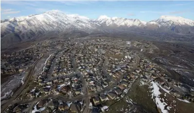  ?? The Associated Press ?? ■ Rows of homes are shown in suburban Salt Lake City on April 13, 2019. Utah is one of two Western states known for rugged landscapes and wide-open spaces that are bucking the trend of sluggish U.S. population growth. The boom there and in Idaho are accompanie­d by healthy economic expansion, but also concern about strain on infrastruc­ture and soaring housing prices.