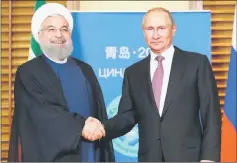  ??  ?? Putin meets with Iranian President Hassan Rouhani on the sidelines of the Shanghai Cooperatio­n Organisati­on (SCO) Summit in Qingdao. — AFP photo