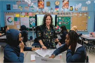  ?? HIROKO MASUIKE/THE NEW YORK TIMES ?? Marisa Shuman with some of her students Jan. 19 at a school in the Bronx borough of New York.