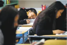  ?? Gabrielle Lurie / The Chronicle 2018 ?? Makisha Brogan (center) rests during class at Phillip and Sala Burton High School in San Francisco. Some say early school starts are unhealthy for teens.