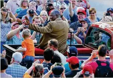  ?? CURTIS COMPTON/AJC 2014 ?? Hank Aaron waves to fans from the back of a pickup during the Hall of Fame Legends Parade down Main Street in July 2014 in Cooperstow­n, New York.