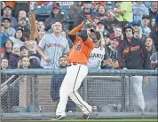  ??  ?? The Giants’ Pablo Sandoval grabs a foul ball hit by the Padres’ Freddy Galvis in the fourth inning Friday night.