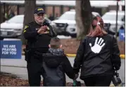  ?? BILLY SCHUERMAN — THE VIRGINIAN-PILOT VIA AP ?? Sgt. Jamie Huling of the Newport News Police Department greets students as they return to Richneck Elementary in Newport News, Va., on Monday.