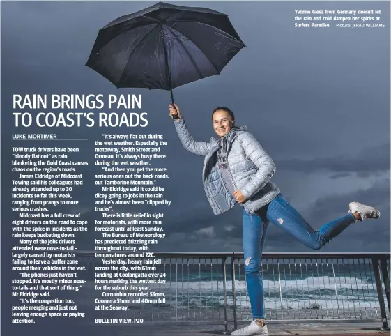  ?? Picture: JERAD WILLIAMS ?? Yvonne Giesa from Germany doesn’t let the rain and cold dampen her spirits at Surfers Paradise.