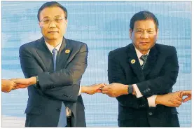  ?? BULLIT MARQUEZ / ASSOCIATED PRESS ?? In September, Philippine President Rodrigo Duterte (right) met with Chinese Prime Minister Li Keqiang at an ASEAN summit in Laos. This week, Duterte is on a state visit to China that may show how far he wants to shift ties away from the U.S.