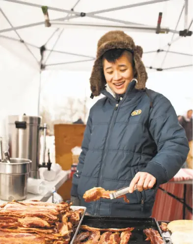  ?? Photos by Craig Lee / Special to The Chronicle 2011 ?? Jaymes Luu, above, serves snacks at Fat Face at the Davis Farmers’ Market.