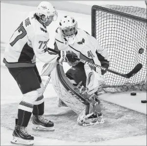  ?? CP PHOTO ?? Washington Capitals forward T.J. Oshie scores on his goaltender Gavin McHale during the warm-up period prior to NHL action against the Winnipeg Jets in Winnipeg on Wednesday.