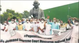  ?? PTI ?? Opposition parties’ MPs stage a protest against Pegasus project during the monsoon session on July 23. The defence ministry on Monday denied any contract with the spyware maker, NSO group.